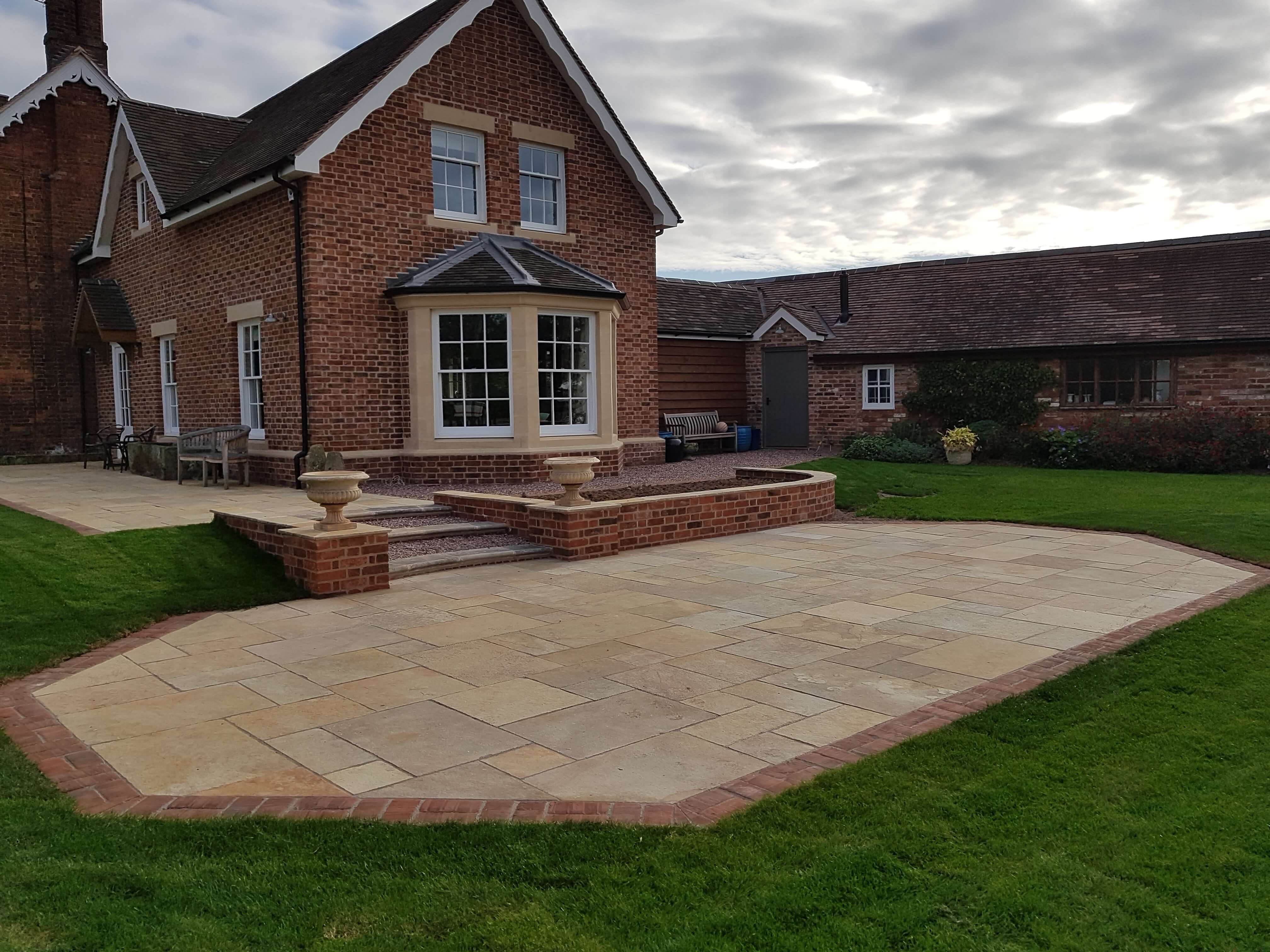 Sandstone patio with brick edging