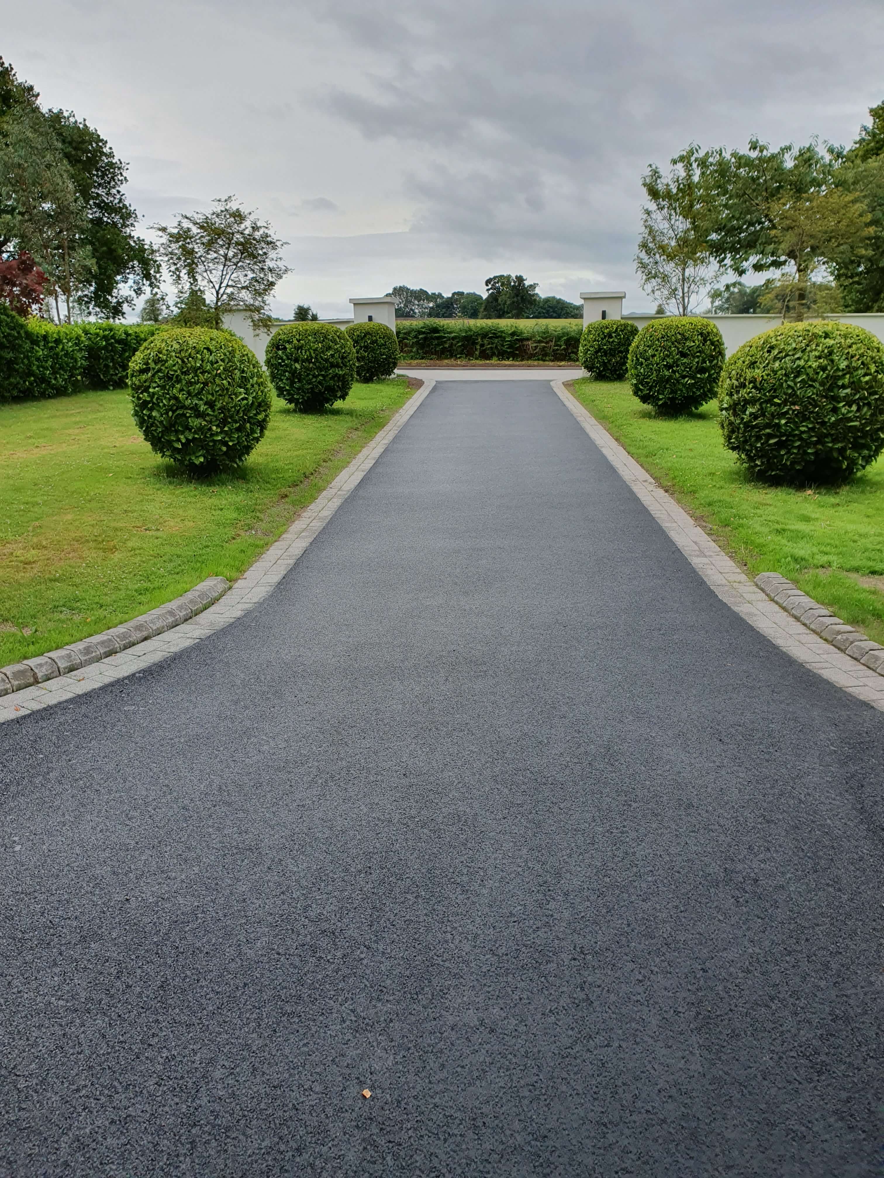 Tarmac driveway with topiary hedging